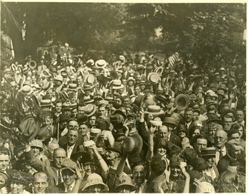 View of townspeople greeting Davis in his front yard after his arrival.