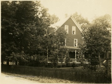 View of the Misses Harding's residence surrounded by trees in Elkins.