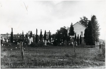 Small church sits near a cemetery.