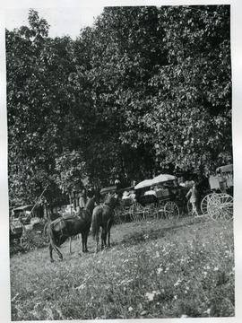 People along with their horses and buggies are at the fairgrounds in Pennsboro, West Virginia.