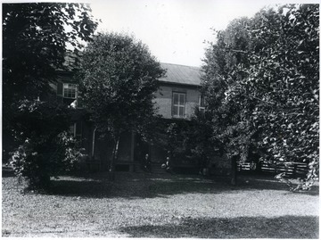 People sit on the front porch for the photograph.