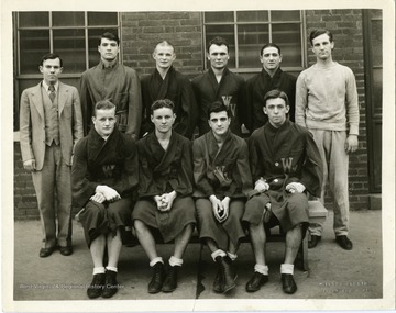 Group portrait of the West Virginia University Boxing Team taken on March 21, 1934 in front of Field House.