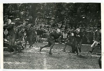 Possibly Ed Williams, is carrying the ball during the Peach Bowl in Atlanta, Georgia. West Virginia University played the University of South Carolina.
