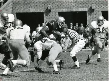 West Virginia University versus William and Mary.  Garrett Ford '32', through William and Mary line for a first down.  'This photograph is property of The Richmond Times- Dispatch, The Richmond News Leader, and must not be used without permission.'