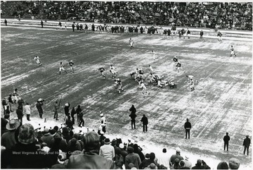 Running play to the left side of the line on a Winter's day at Mountaineer Field.