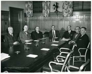 Picture was taken in the Board of Governors Room in Stewart Hall.  'Left to right: 1. Mr. A.C. Spurr, 2. Dr. Thomas L. Harris, 3. Mr. James M. Guiher, 4. Dr. Irvin Stewart, 5. Mr. Douglas K. Bowers, 6. Mr. Charles Hodges, 7. Governor Okey L. Patteson.'