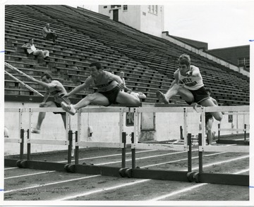 Hurdles competition between the track members of Ashland and West Virginia University.
