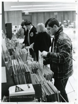 Customers are looking at records that are displayed in the basement of the University Bookstore.