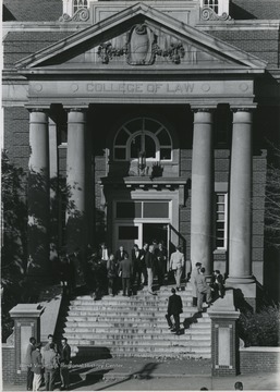 Men standing at steps of Colson Hall.
