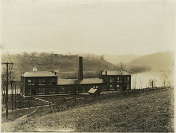 'Mechanical Hall by the river, (built 1892-4, destroyed by fire, 1899).  Note the small powder house in the foreground.  The U. heating plant now occupies the site John L. Johnston was professor of Engineering during this period.  The negative was made by Johnston about 1895, is now the department of physics. (1940)'