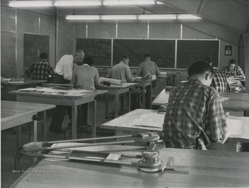 View of students in classroom of Engineering Science building.  Henry Speeden located left, with white shirt.