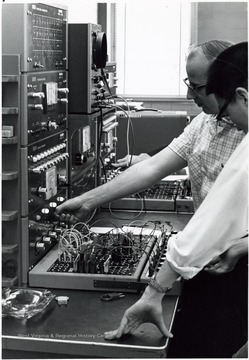 View of two men operating first (analog) computer at Engineering Sciences building.