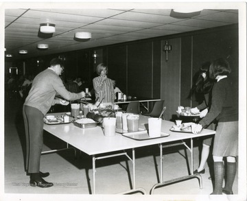 'Condiment table in Westchester Hall cafeteria, West Virginia University, is surfaced with the same 'Doublewear' Micarta laminated plastic as serving counters and tables. It retains its clean shine without waxing and resists both food stains and abrasion marks made by sliding trays.'