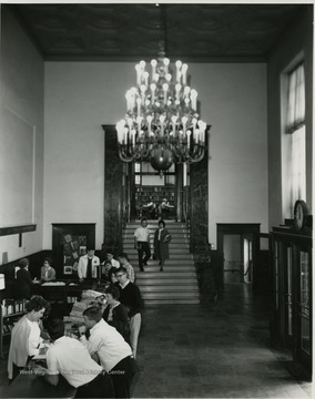 Interior view of library.  Behind desk, from left to right- Elizabeth Douglas, circulation assistant; Michele Tannahill, circulation assistant; Virginia Perry, circulation librarian. 