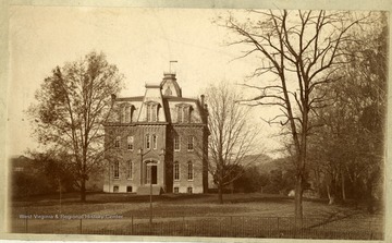 'Woodburn Hall, West Virginia University, before either wing was built. Taken from University Avenue, then called Front Street, in the late eighties. Property of Jas. R. Moreland.'
