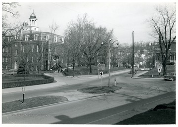 View of University Avenue at its intersection with College Avenue on the WVU Downtown campus.  Grumbein Island in center of street.  Martin Hall, Chitwood ('Science') Hall, and WVU Agricultural Experiment Station buildings visible. 