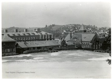 'Left to Right: Corner Mechanical Hall, Chemistry, old cafeteria (later used for buildings and grounds), Administration, & bleachers in back of Reynolds Hall.'
