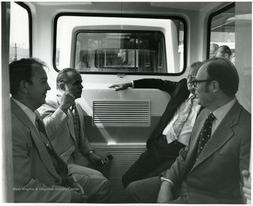 'Left foreground-- George Kirk, Vice-President For Finance, Left background-- Hal Shamberger--Administrative Assistant to the President, Right foreground--Ben Morton--President, W. Va. Board of Regents, Right background--unknown.'