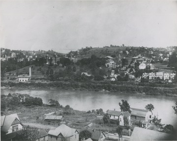 The photograph includes the first Mechanical Hall along the river. It was destroyed by fire in 1899.