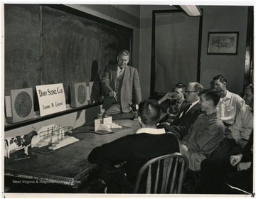 Instructor leading a demonstration, 'Learning by Experience' at The Diary Science Club.