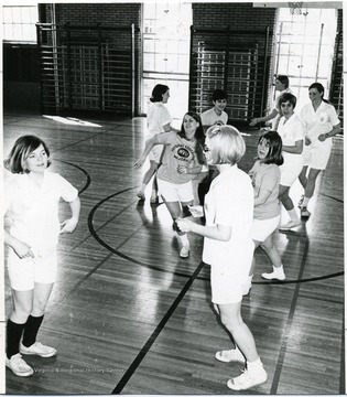 Women participate in activity during physical education class.