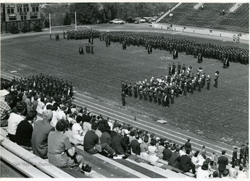 Reserve Officer Training Corps Units, including the band form on Mountaineer Field and pass in review as spectators watch from the stands.