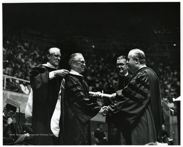 Left to right: First man unidentified, G. Paul Moore, Dr. Munn, and President Harlow.