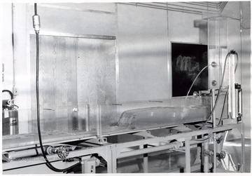 'This Hydraulic laboratory Unit was built for us by the Engineering Experiment Station at the University of Wisconsin. Orifice, weir, pipe, open channel and many other types of flow can be demonstrated.' Image from page 22 of 'Progress Report on Civil Engineering Submitted to Education Committee, Engineers Council for Professional Development 29 West 39th Street, New York 18, New York by College of Engineering, West Virginia University, Morgantown, West Virginia.' Original photo may be found in this publication located in the WV Collection book collection. 