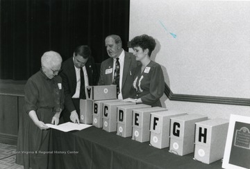 John Cuthbert, Curator, West Virginia and Regional History Collection, Second from left with head down.