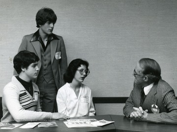 University Foundation Scholarship Candidates speak with Dean of Admissions and Records, John Brisbane at Central Preston Senior High School, Kingwood, 1980.