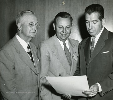 'P.I. Reed (Chairman, Committee on Awards), Alvin E. Austin (director of department of Journalism, University of North Dakota, and president of the American Society of Journalism School Administrators), and Frank Shea (foreign correspondent and assistant to the publisher of the news magazine, Time) at the time ASJSA presented its eighth annual publication award 1953/08/26 at Michigan State College. Mr. Shea delivered the main luncheon address that day.'