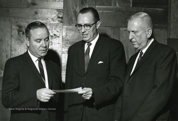 Chester A. Arents, center, Dean of West Virginia University`s College of Engineering, accepts a $3,000 check from D.C. York, right, President of Petroleum Industry Electrical Association, Charleston. Looking on is Ed Wallace of Consolidated Gas Supply Corporation, Clarksburg. The check will be used to establish an interest-free loan fund for qualified junior, senior, and graduate students in electrical engineering.