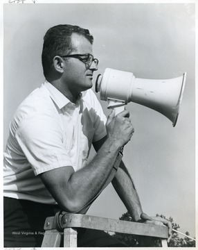 Budd Udell directing the band with megaphone and baton.
