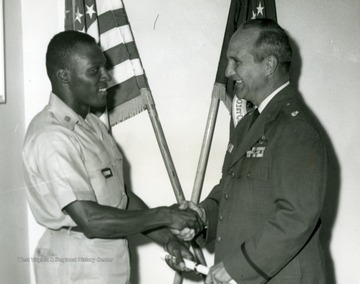 'Lt. Colonel Helmuth E. Eberhard, Commander of the Lockbourne AFB AFROTC Summer Training Unit, presents the AFROTC Athletic Award to cadet Leonard O. Bloom, AFROTC Department 915, West Virginia University, Morgantown, W.Va. Inclusive dates of the summer training unit were 16 June- 13 July 63. A total of 235 cadets competed for the award.'