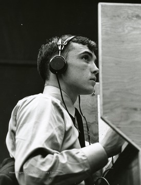 Male student wearing headphones.