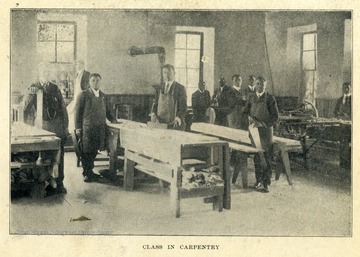 African-American students pose for a photograph in their carpentry classroom.