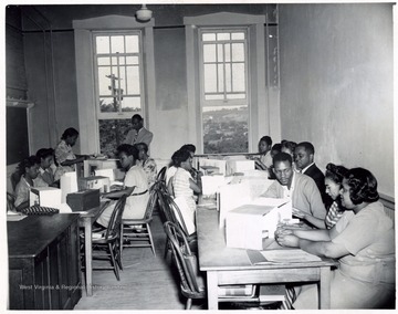 African-American students work on models in a classroom.