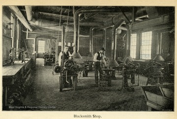 Two men working in a blacksmith classroom.