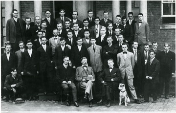 Seated on a chair, far left is Professor William P. Willey and his beloved pet, Bob.  Bob was also the Law College mascot and a favorite of the students. He attended Professor Willey's lectures and was described as "one of the boys".  See the 1911 Monticola, p. 83-86 for a memorial and Professor Wiley's eulogy he delivered in class after Bob's untimely death. 