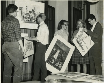 Second from left, in white shirt, standing in front of big painting, is Jim Wison. 