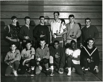 Group of male athletes, possibly wrestlers, posed for a portrait.