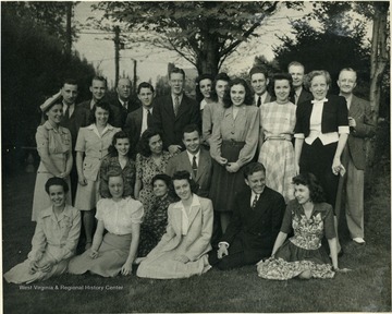 Class of 1942 from the School of Journalism pose with Dr. and Mrs. P. I. Reed.  The Reeds stand far right and Prof. Wild stands to the far left.  Mrs. Reed was an English teacher.  