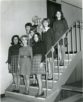Female members of Junior Panhellenic Council pose on a staircase.