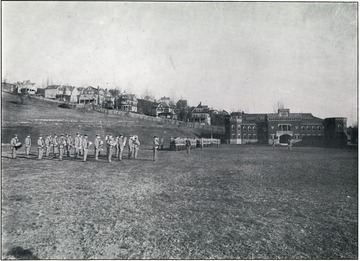 WVU R.O.T.C units and band on the Drill Field.  The Amory is visible in the background. 