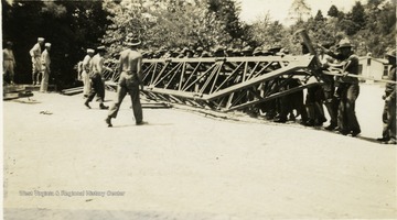 Cadets pushing up a truss.