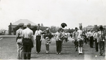 The ROTC band and sponsors dressed in costume.