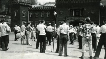 The R.O.T.C. band performs in front of Armory while onlookers listen.