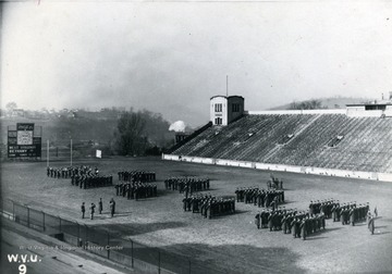 Cadets in uniform assemble in Mountaineer Field.