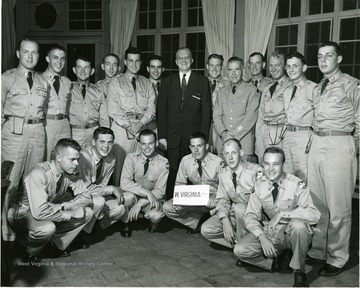 'West Virginia U. cadets -- Undergraduates of West Virginia University, attending Signal Corps' ROTC encampment at Fort Monmouth, N.J., assemble with college's vice president C.T. Neff, Jr., during his three-day visit of camp activities. Left to Right (kneeling): William Long, John Heckert, Albert Lewis, James Heatherly, Richer Csamer, and John Leachman.  Standing: Kenneth Skidmore, Davide McWhorter, Gerald Swecker, William Lodge, Robert Kay, Arthur Sites, Vice President C. T. Neff, Jr., Robert Borke, Lt. Col. B. Cooper, James McDonald, Elmer Clear, Robert Calligan, and Donald Richardson.'