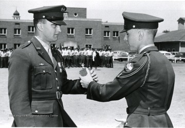 A cadet receives a trophy.